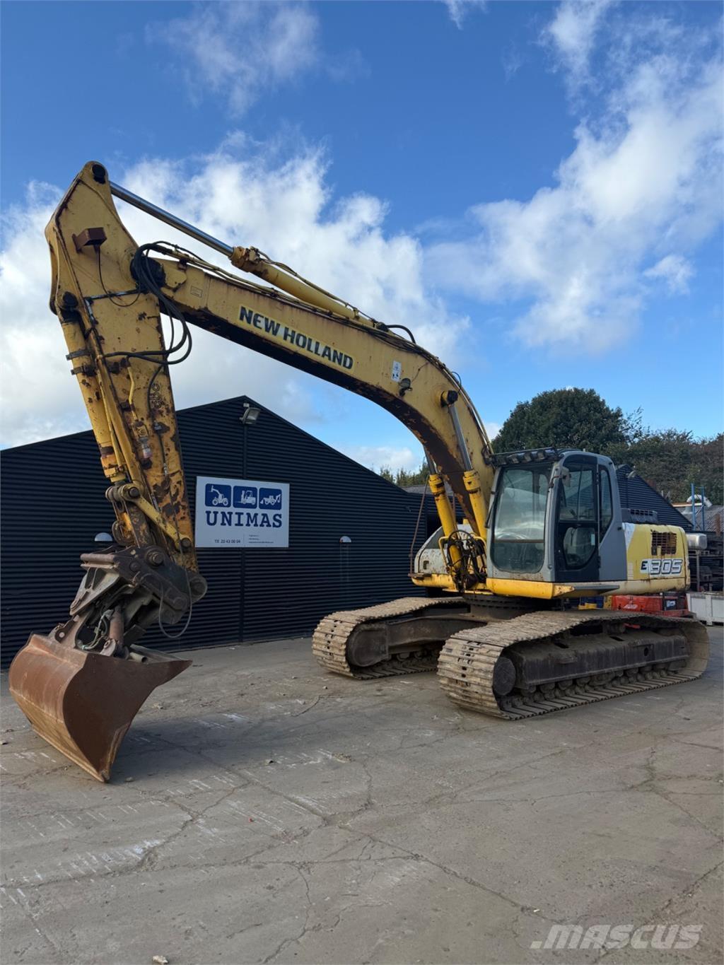 New Holland E305 Bageri guseničari