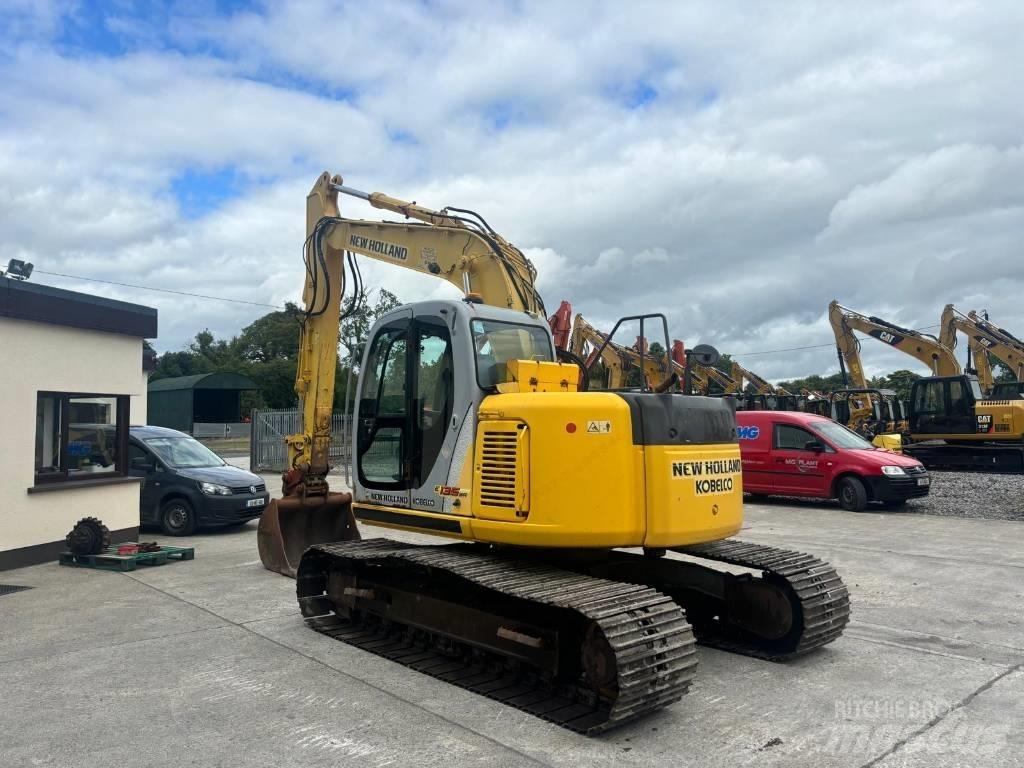 New Holland E 135 SR Bageri guseničari